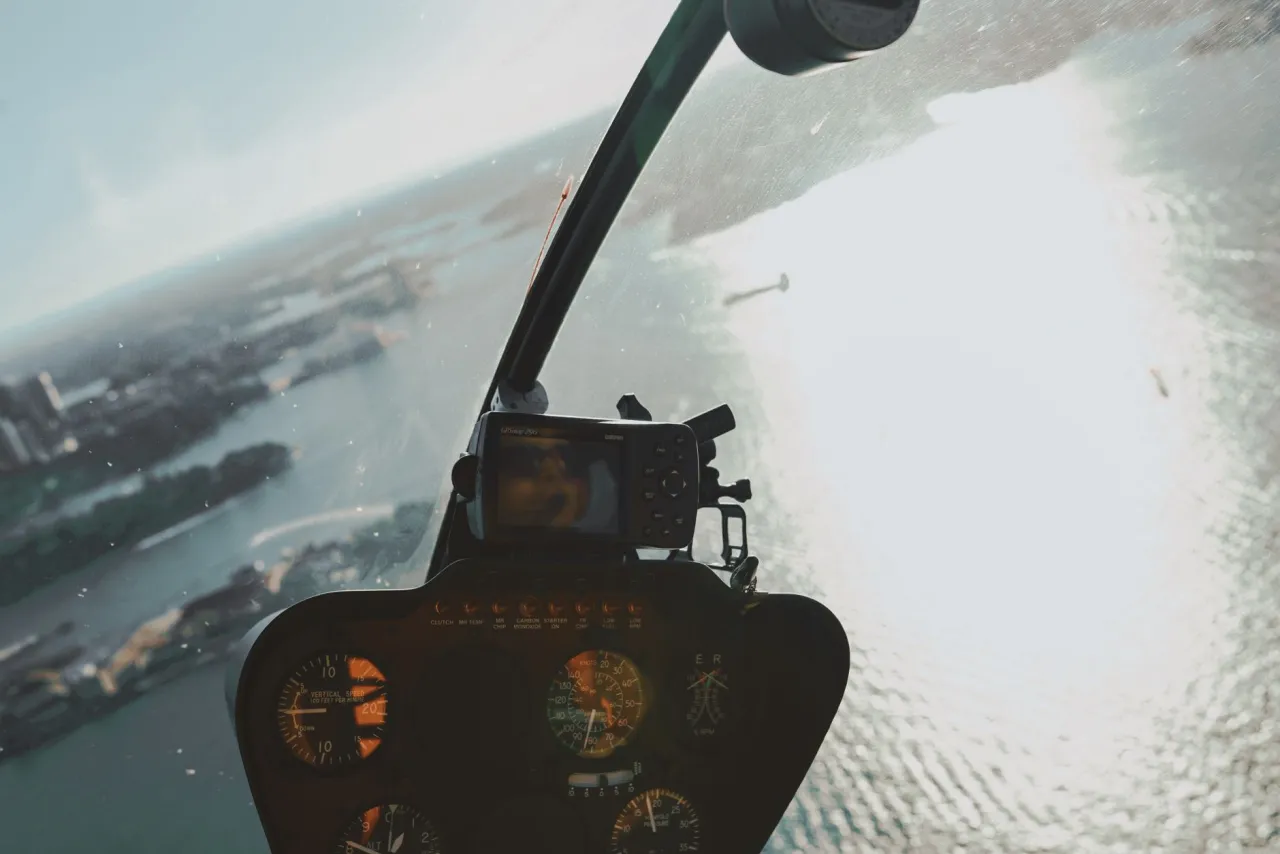 The view out of a helicopter door over the landscape